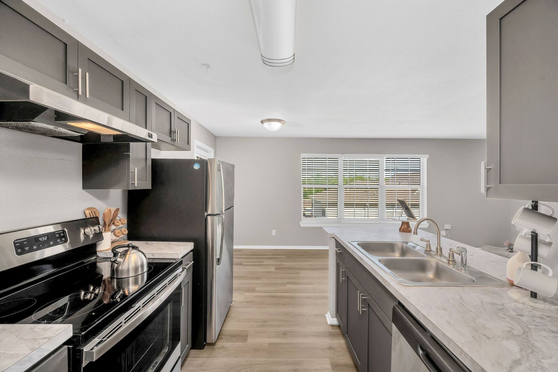 Luxury apartment kitchen with stainless steel appliances, granite countertops, and lots of storage space